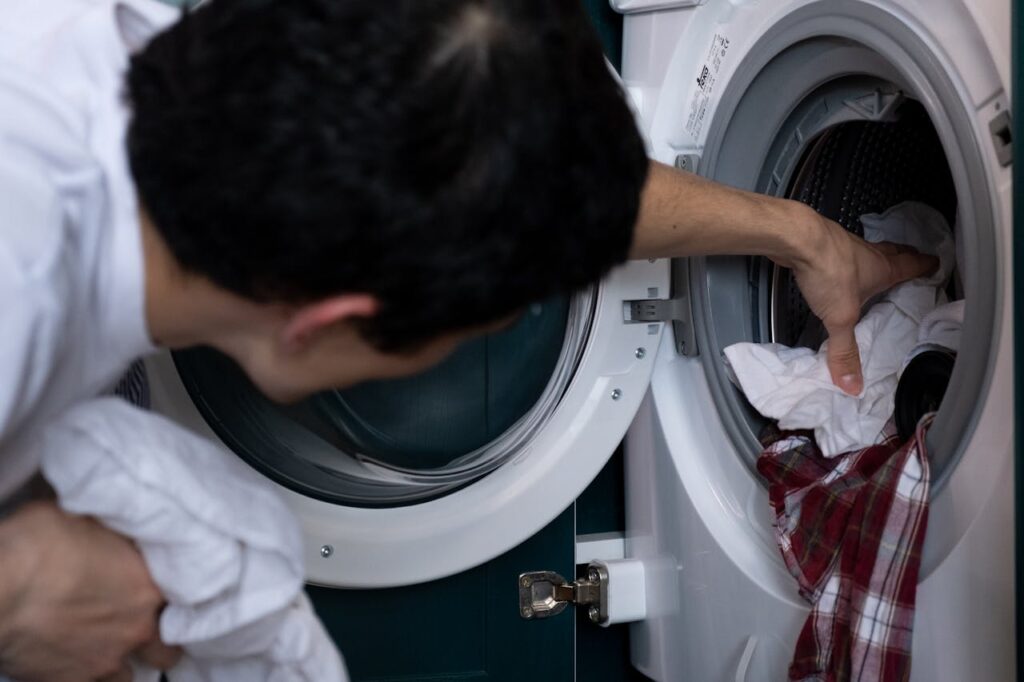 pexels-photo-5901622 Man Taking Laundry out of the Washing Machine